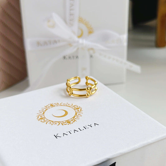 Gold U-Ring on a gift box, showcasing its stunning design and luxurious packaging.