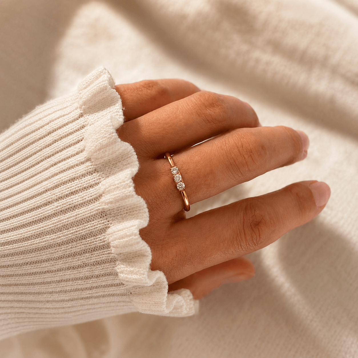 Hand wearing Zoi Gold Crystal Ring showcasing three cubic zirconia stones on a sleek gold band.