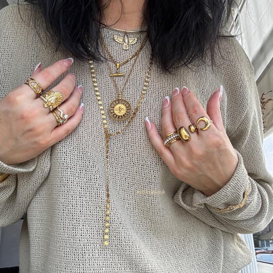 Woman showcasing layered gold jewelry, highlighting the latest Trending Jewelry styles in 2026.