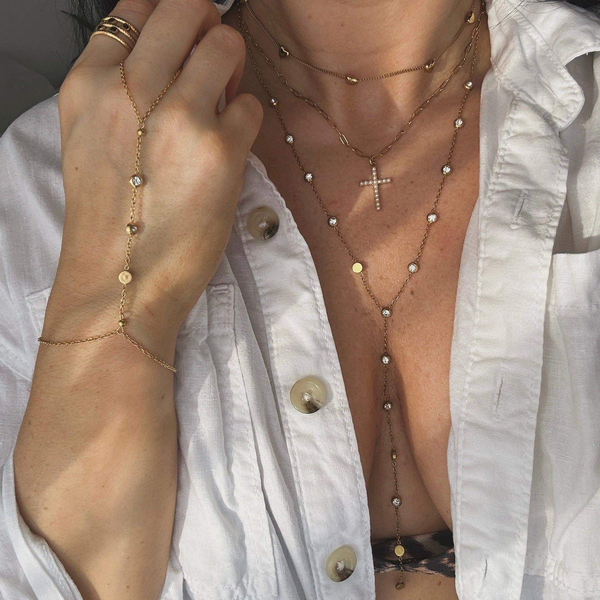 Kataleya's Bestsellers Collection featuring layered jewelry with gold plating and pearls worn by a modern goddess.