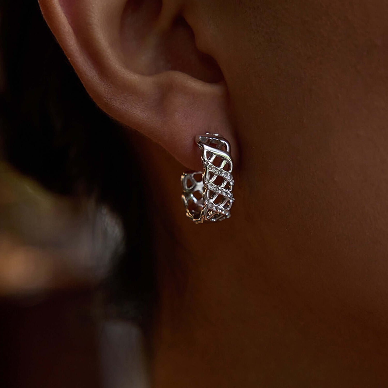 Photo featuring silver crystal lattice earrings on a womans ear by Kataleya Jewellery