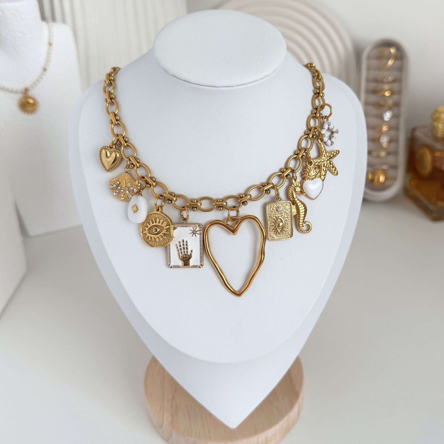 charm necklaces collection with gold chain and various meaningful charms including hearts and stars.