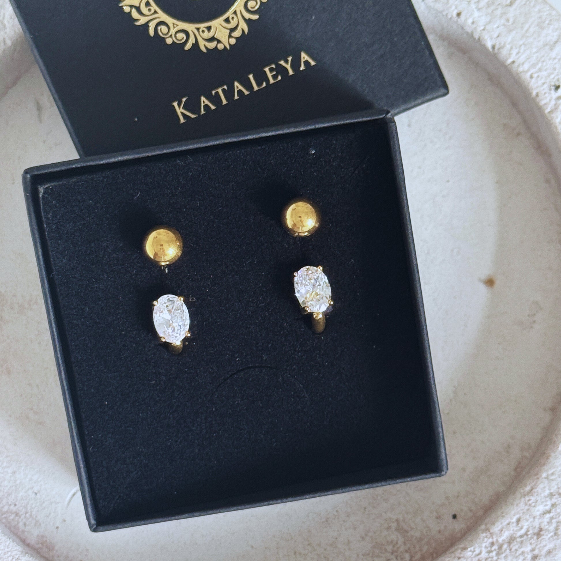 Gold Crystal Hoop Earrings displayed in a sleek box, showcasing their elegant design with cubic zirconia stones.