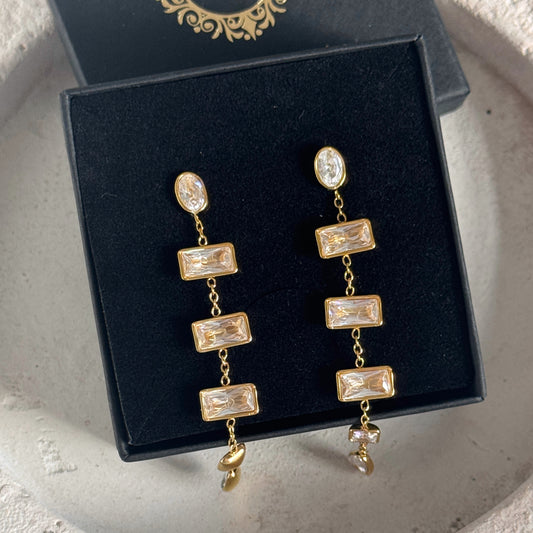 Gold Baguette Drop Earrings displayed in a black jewelry box, showcasing elegant linear sparkle and modern design.