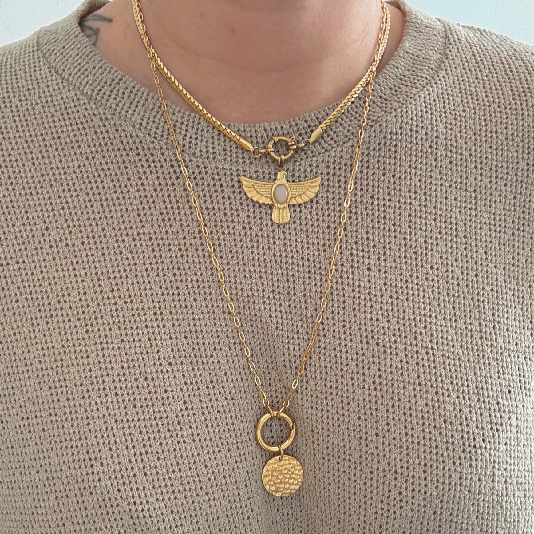 Two layered necklaces featuring a textured coin pendant and an elegant charm, showcasing the Coin Carabiner Necklace style.