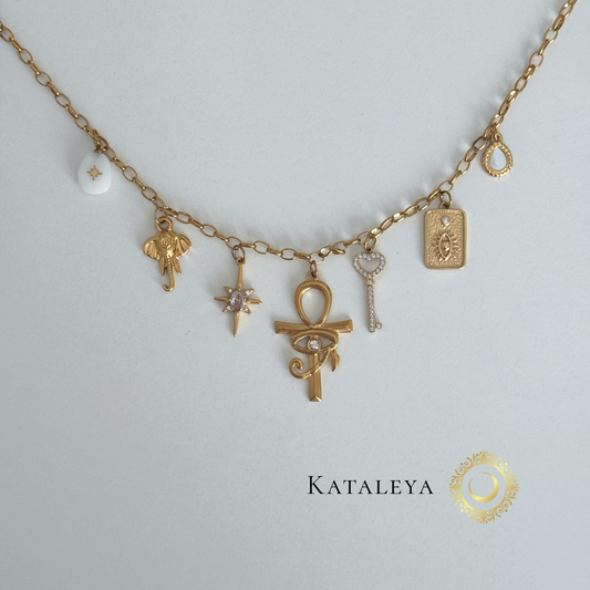 Ankh Goddess Necklace featuring gold charms including a large ankh, elephant, star, and sparkling key on a delicate chain.
