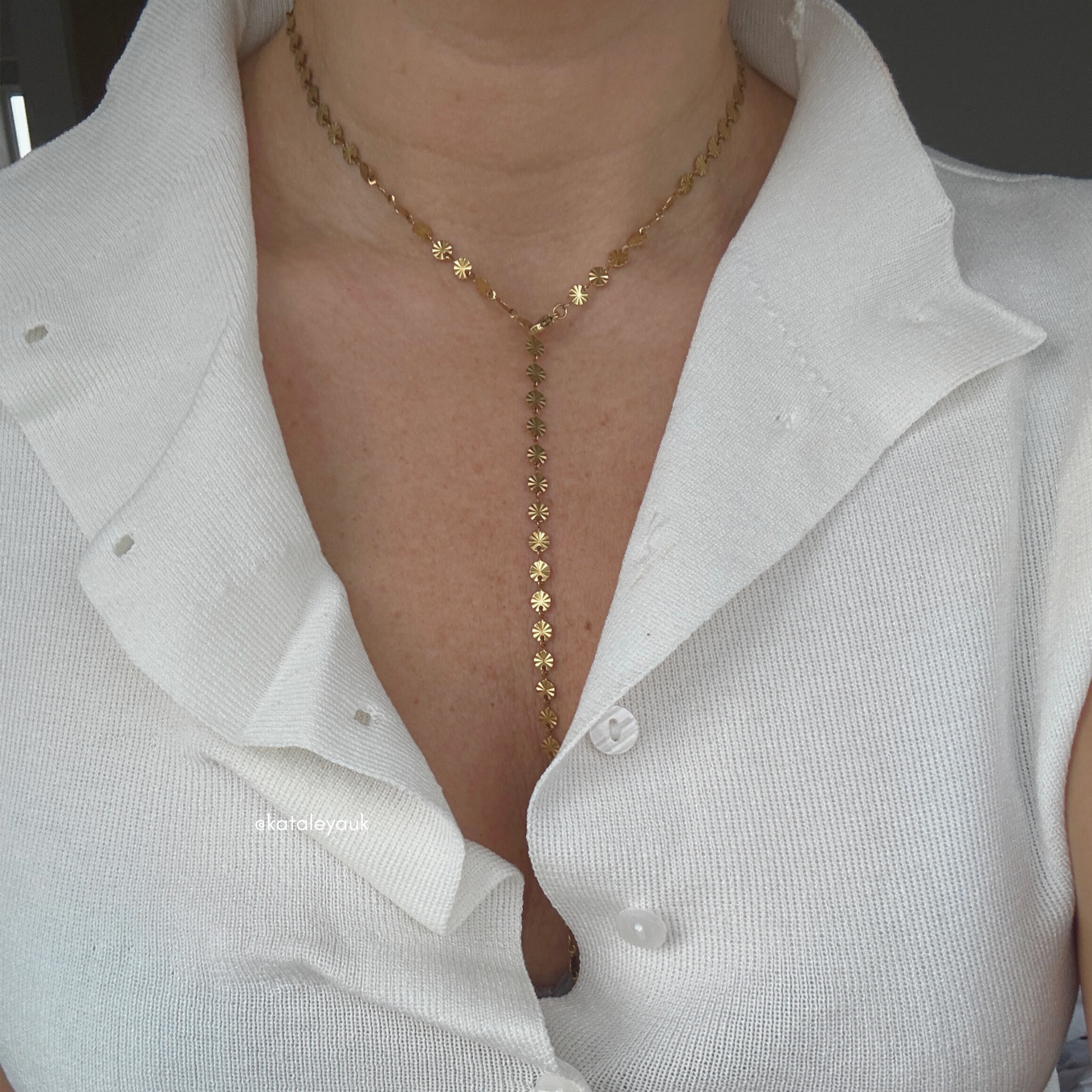 Long Disc Lariat Necklace – Waterproof | Tarnish Free worn with a white top, showcasing its elegant design and gold finish.