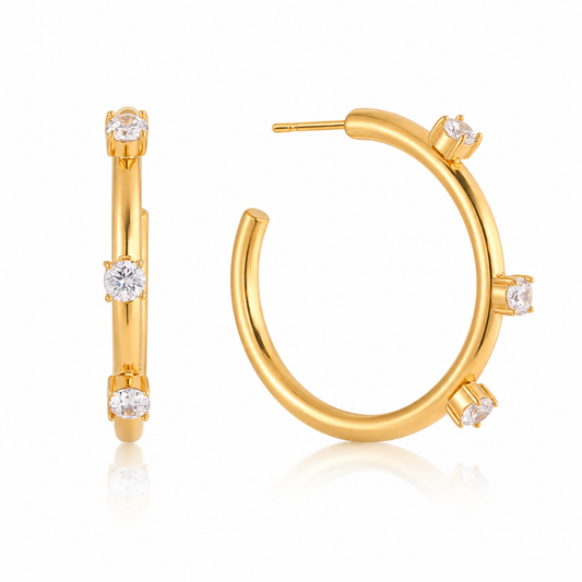 Callisto Crystal Hoops featuring gold plated stainless steel and three round crystals for a stunning look.