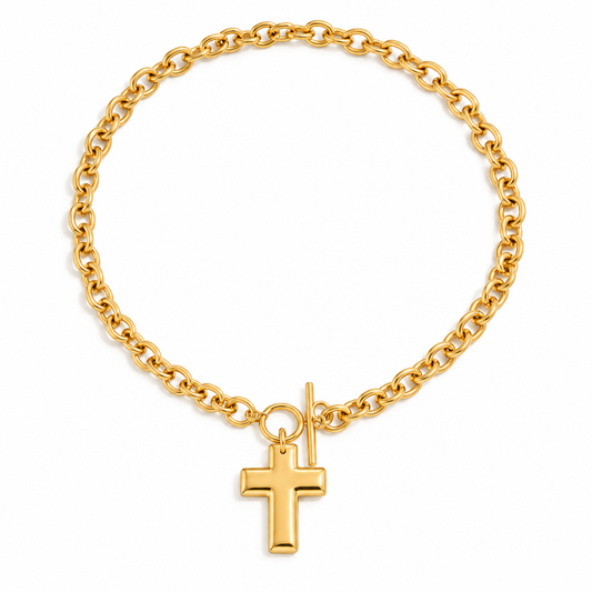 Cassia Cross Necklace featuring a thick gold cable chain and a prominent domed cross pendant with T-bar toggle.