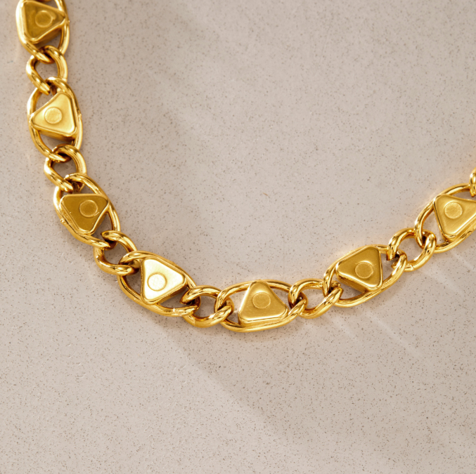 Delphi Crystal Bracelet featuring chunky gold chain with triangular links and cubic zirconia stones.