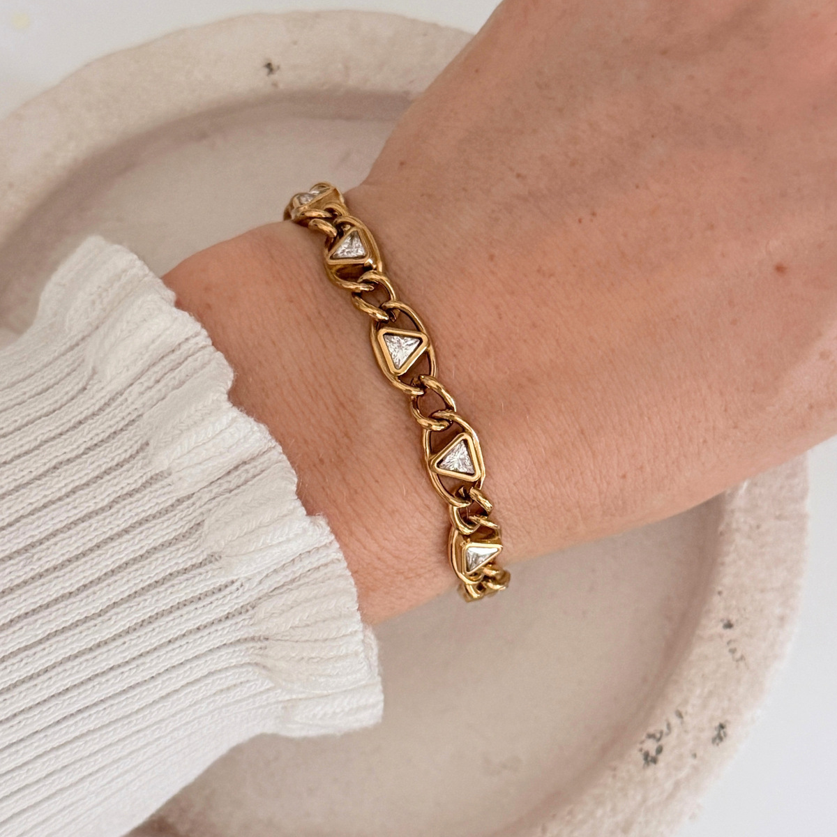Delphi Crystal Bracelet showcased on a wrist, featuring gold chain links and cubic zirconia stones.
