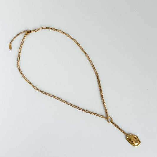 Gold lariat chain necklace with a molten pendant on a white background by Kataleya Jewellery