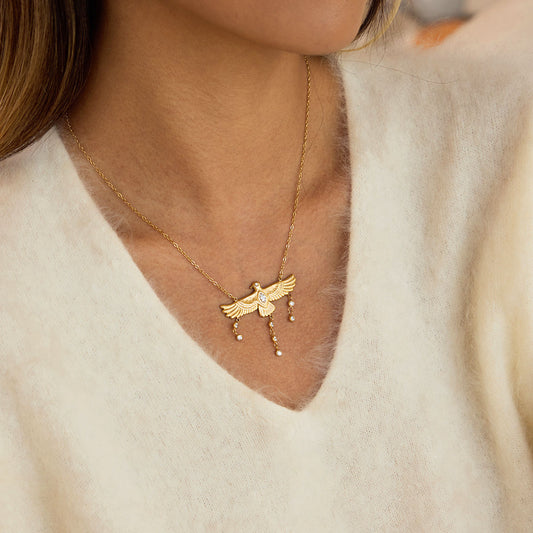 Nekhbet Wing waterproof gold eagle necklace worn on a woman's neck, featuring detailed eagle design and elegant style.