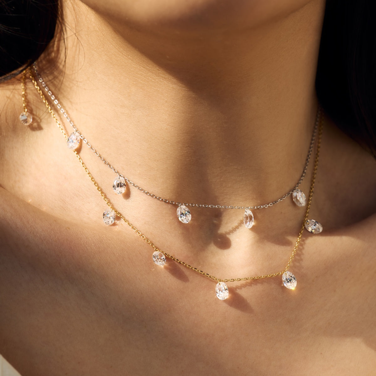 Close-up of a person wearing a Seraphine Radiance - delicate gold necklace with small crystals - Kataleya Jewellery