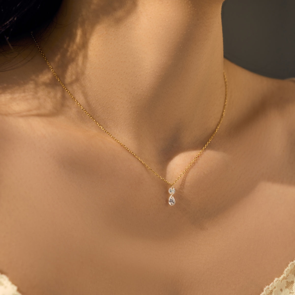 Gold Seraphine Grace necklace with a pendant on a person's neck against a neutral background - Kataleya Jewellery