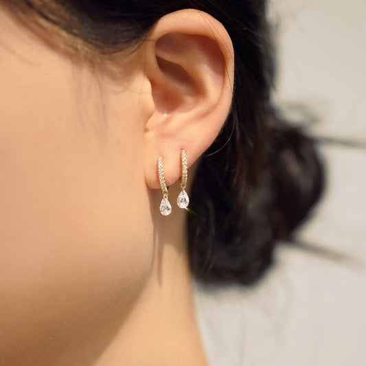 Close-up of an ear wearing teardrop-shaped Seraphine Halo earrings with a blurred background - by Kataleya Jewellery
