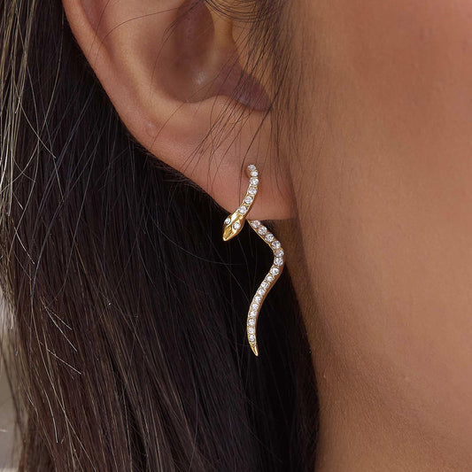 Ophira Serpent Earrings featuring a gold serpent design with crystal pavé set, elegantly curving on the ear.
