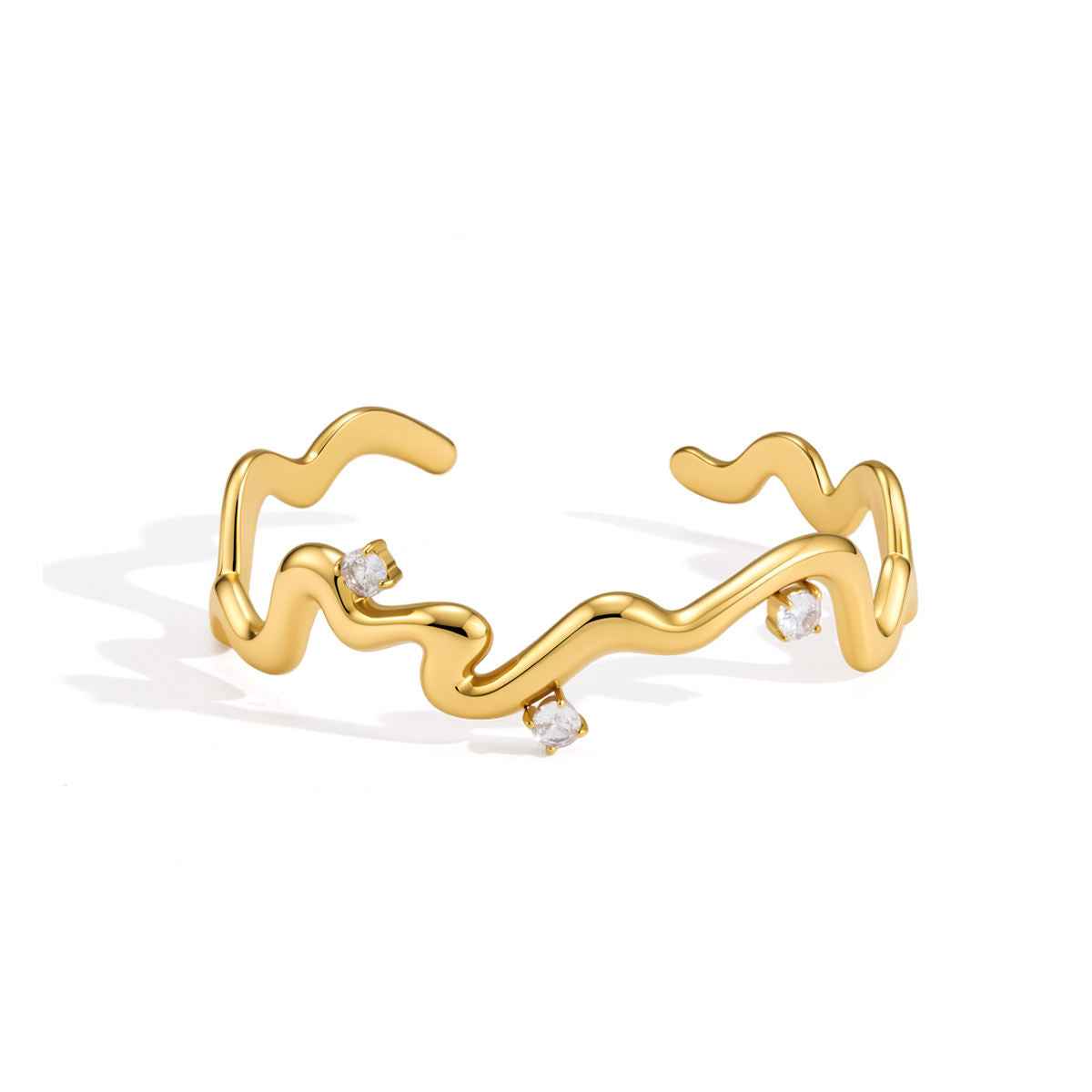 Thalia Squiggle Cuff featuring gold plated stainless steel with three round crystals in a hand-drawn zigzag design.