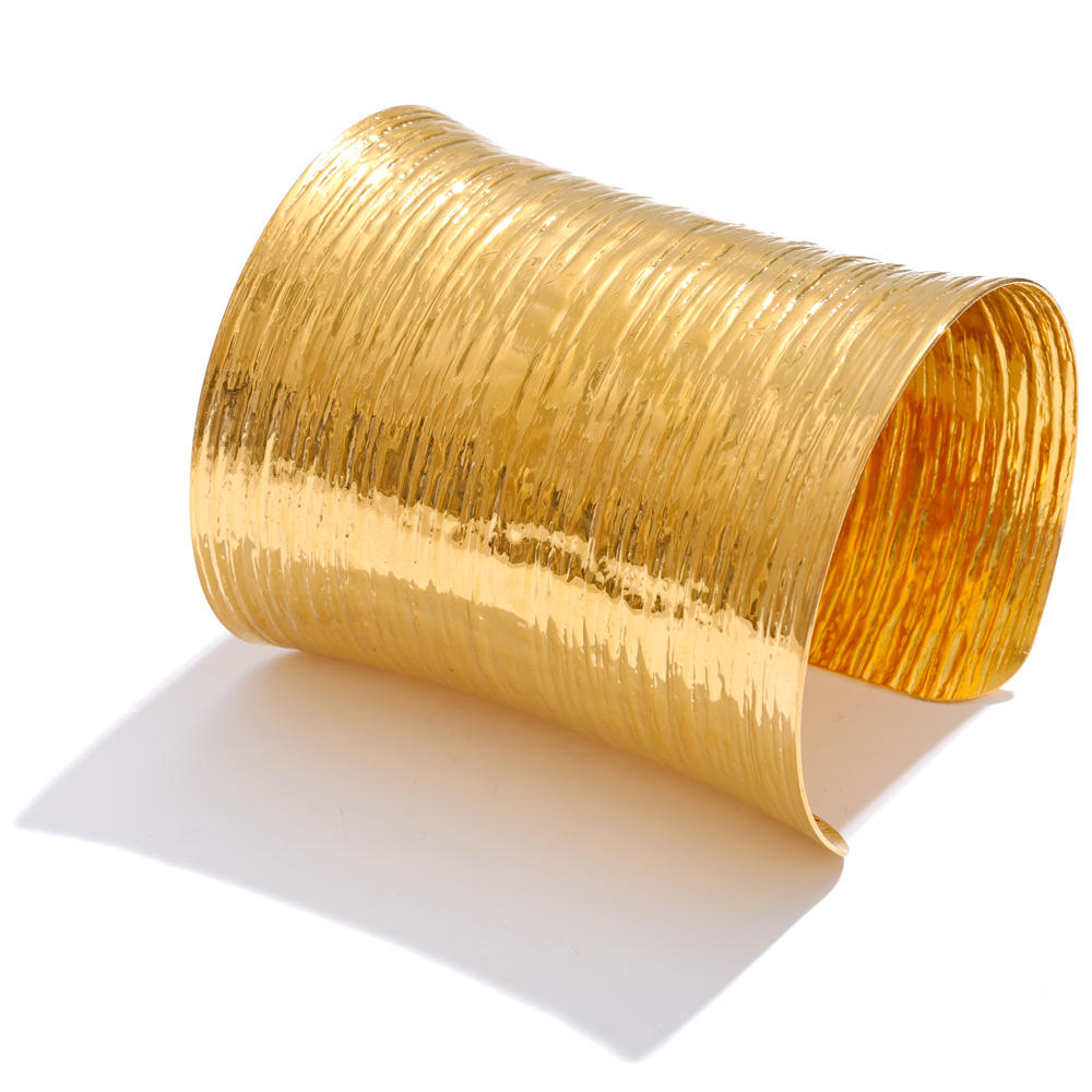 Theia Wide Cuff in gold with a textured surface, 7.5cm long, designed to catch the light beautifully.