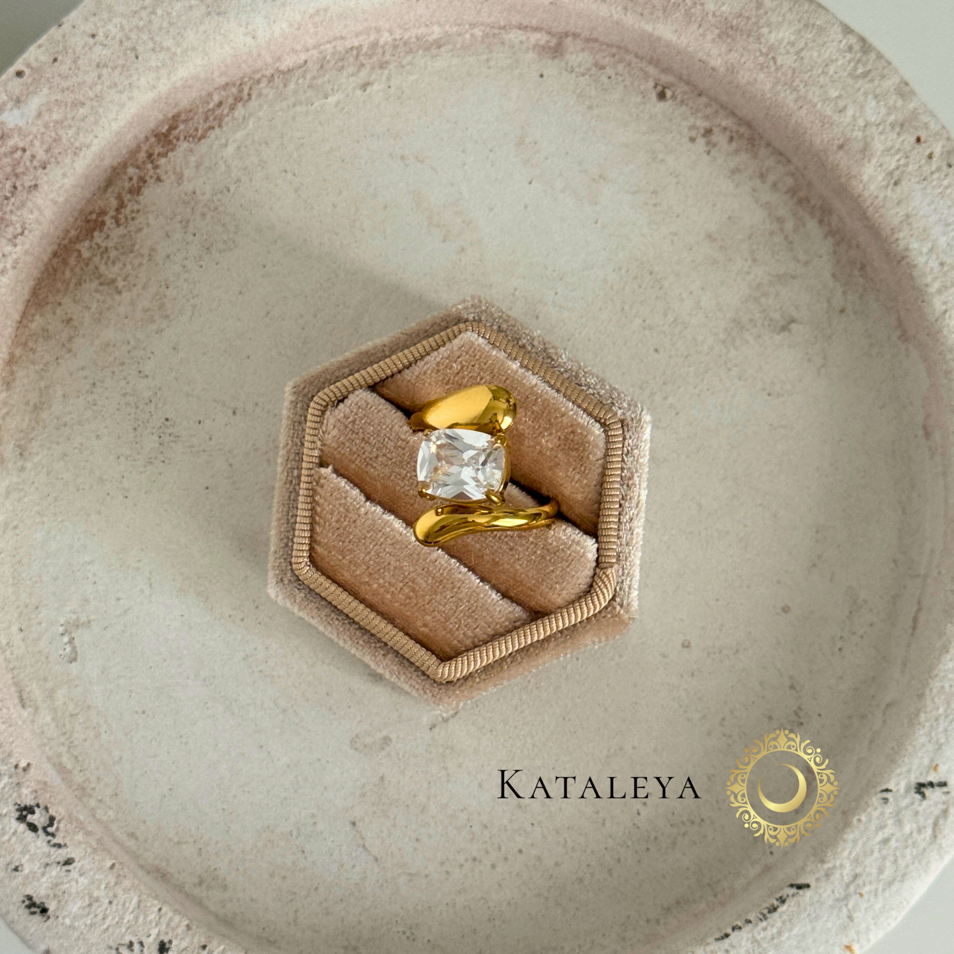 Twist Diamond Ring displayed in a hexagon velvet ring box on a neutral background, showcasing its modern gold finish.