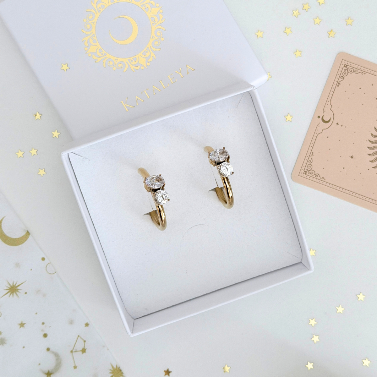 Vega Crystal Hoops displayed in a gift box, showcasing gold plated design and sparkling crystals.