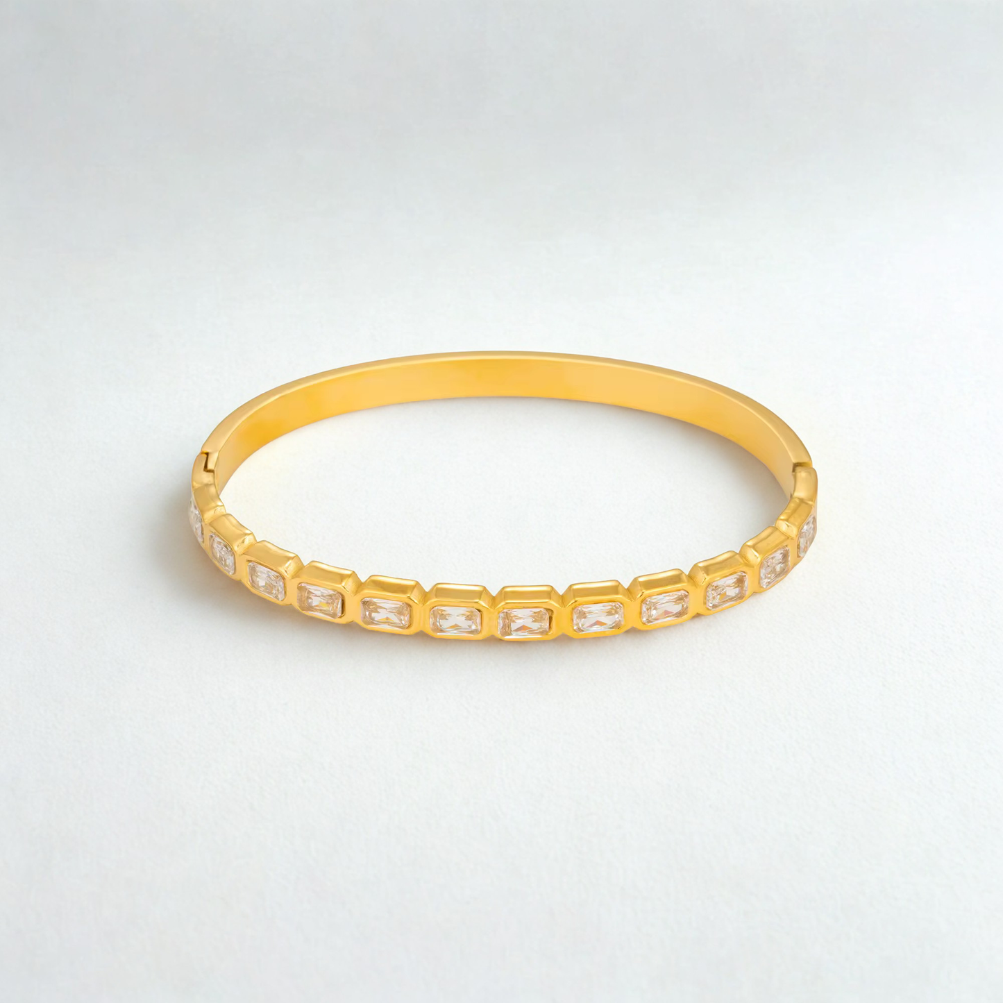 Veyra Waterproof Gold Zircon Bangle featuring rectangular zircon stones in a sleek gold design.