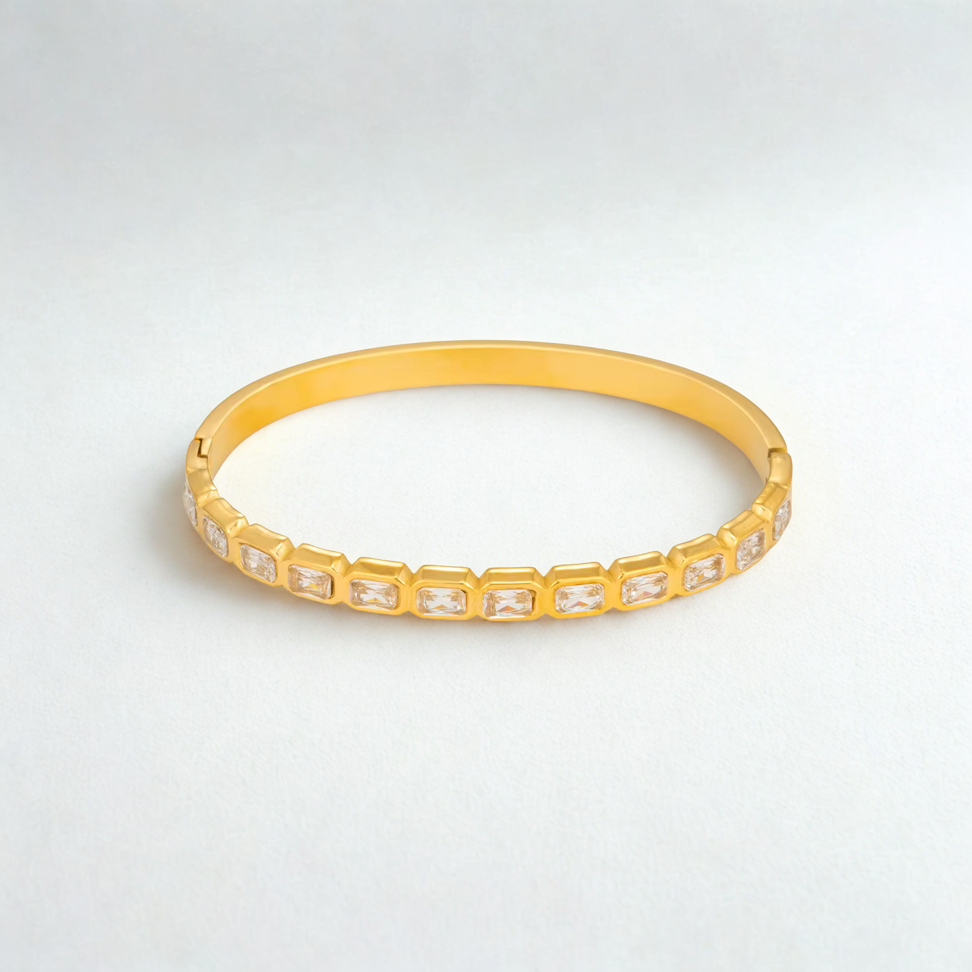 Veyra Waterproof Gold Zircon Bangle featuring rectangular zircon stones in a sleek gold design.