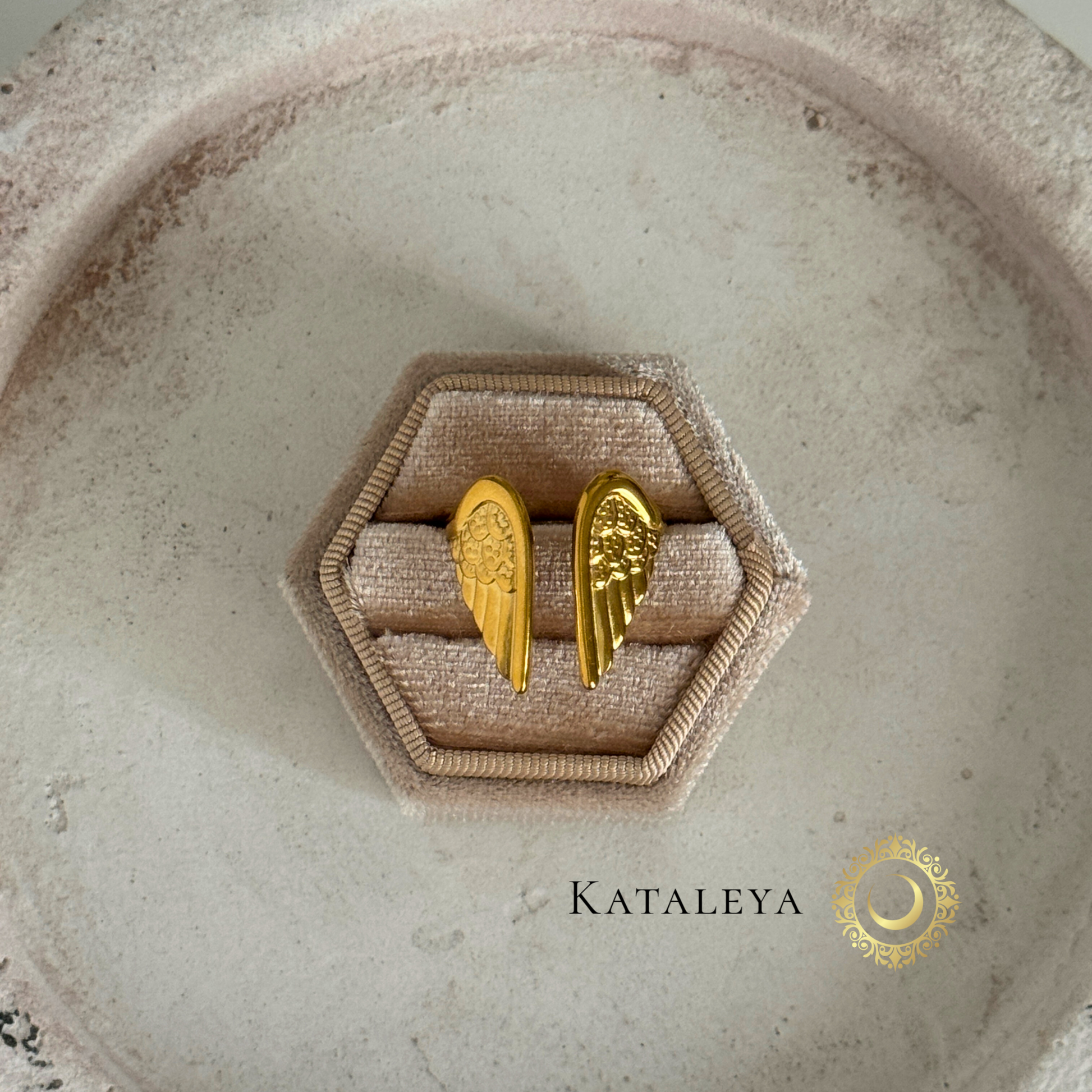 Winged Goddess Ring displayed on a hexagonal ring box, showcasing gold wing details and elegant design.