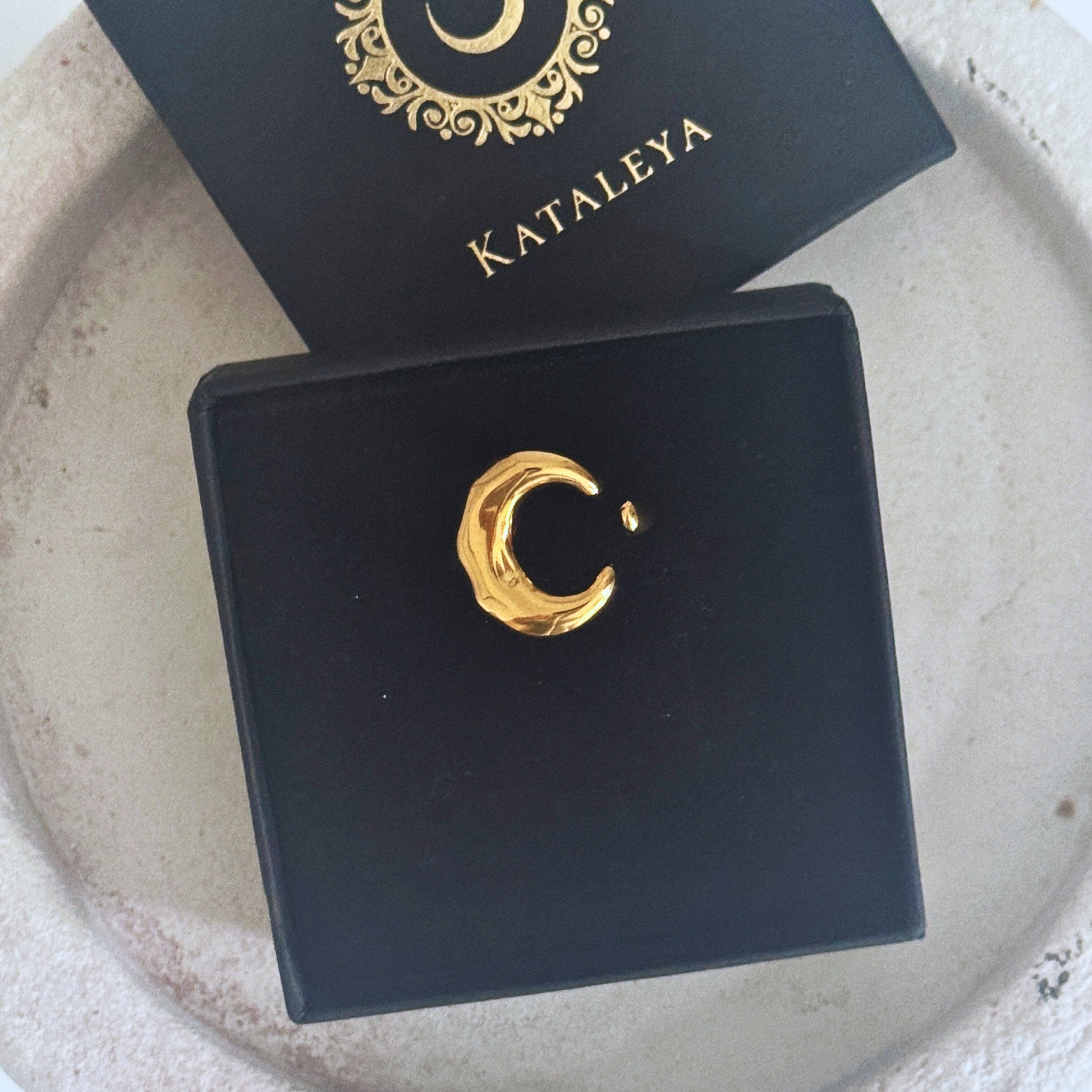 Chunky Gold Moon Ring displayed in black jewelry box by Katalaeya, showcasing its unique crescent moon design.