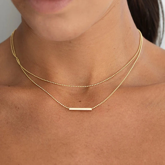 Layered Bar Necklace | Waterproof & Tarnish Free featuring two delicate gold-plated chains and a horizontal bar pendant.