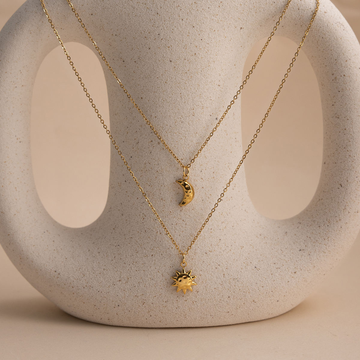Celestial Harmony Necklace featuring sun and moon charms on a gold chain, decorative and elegant waterproof jewelry.