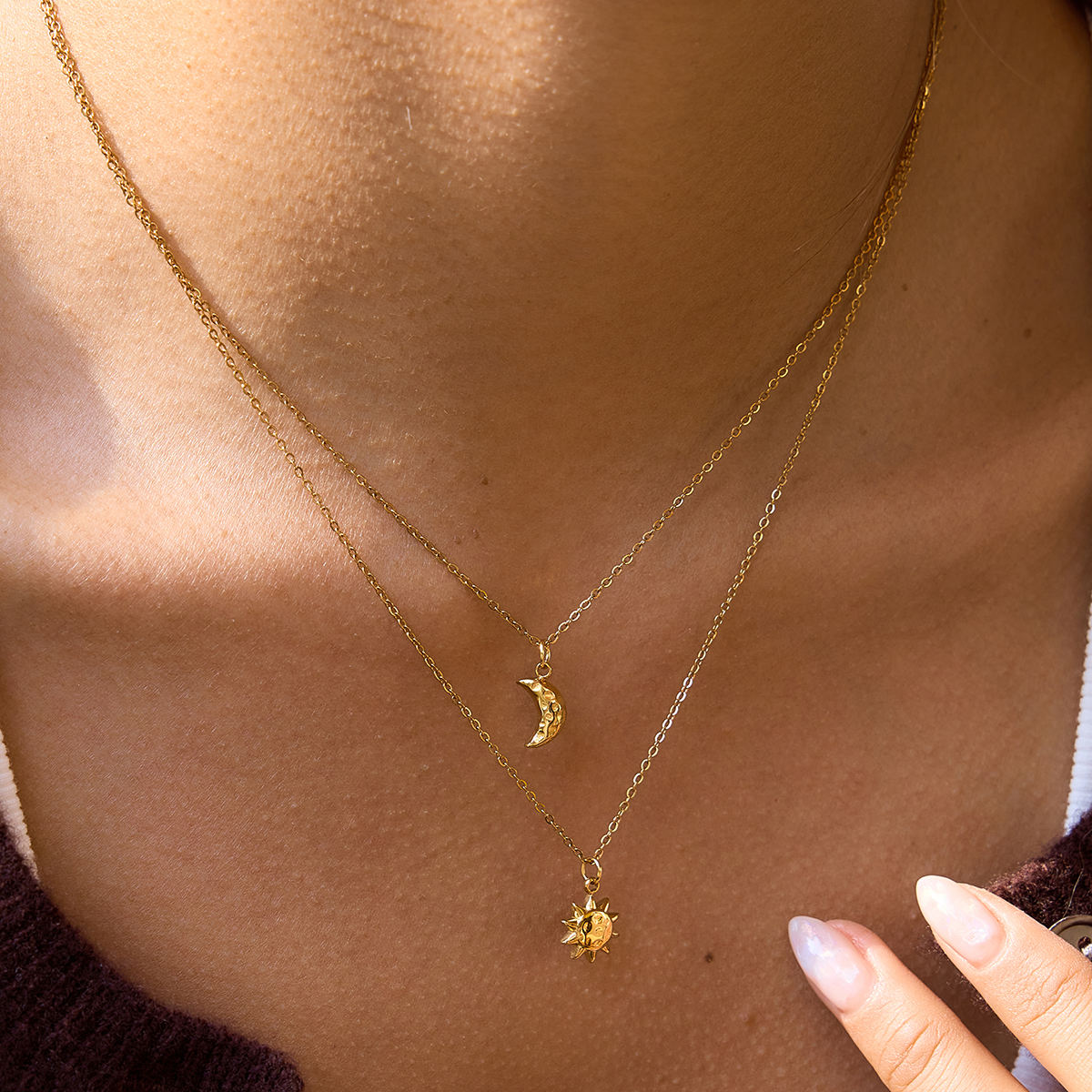 Celestial Harmony Necklace featuring gold sun and moon charms, symbolizing harmony and elegance in waterproof jewelry.