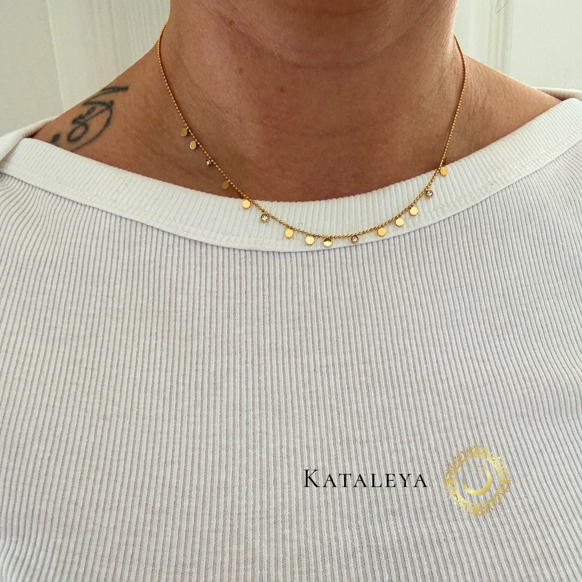 Disc Charm Necklace worn on a person, showcasing its delicate polished discs and minimalist design.