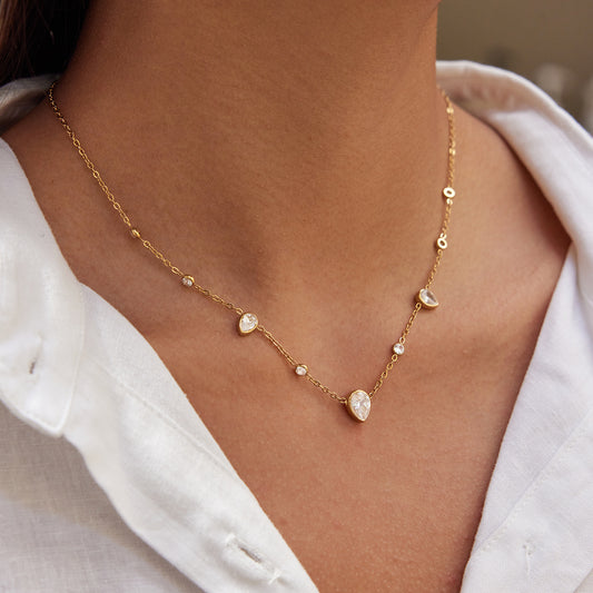 Drop CZ necklace worn on a model, featuring gold chain and sparkling cubic zirconia for a minimal elegant look.
