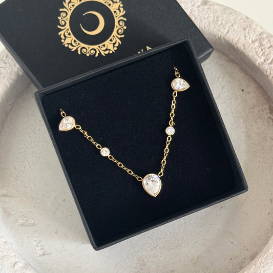Drop CZ necklace showcased in an elegant box with a sleek gold chain and sparkling cubic zirconia accents.