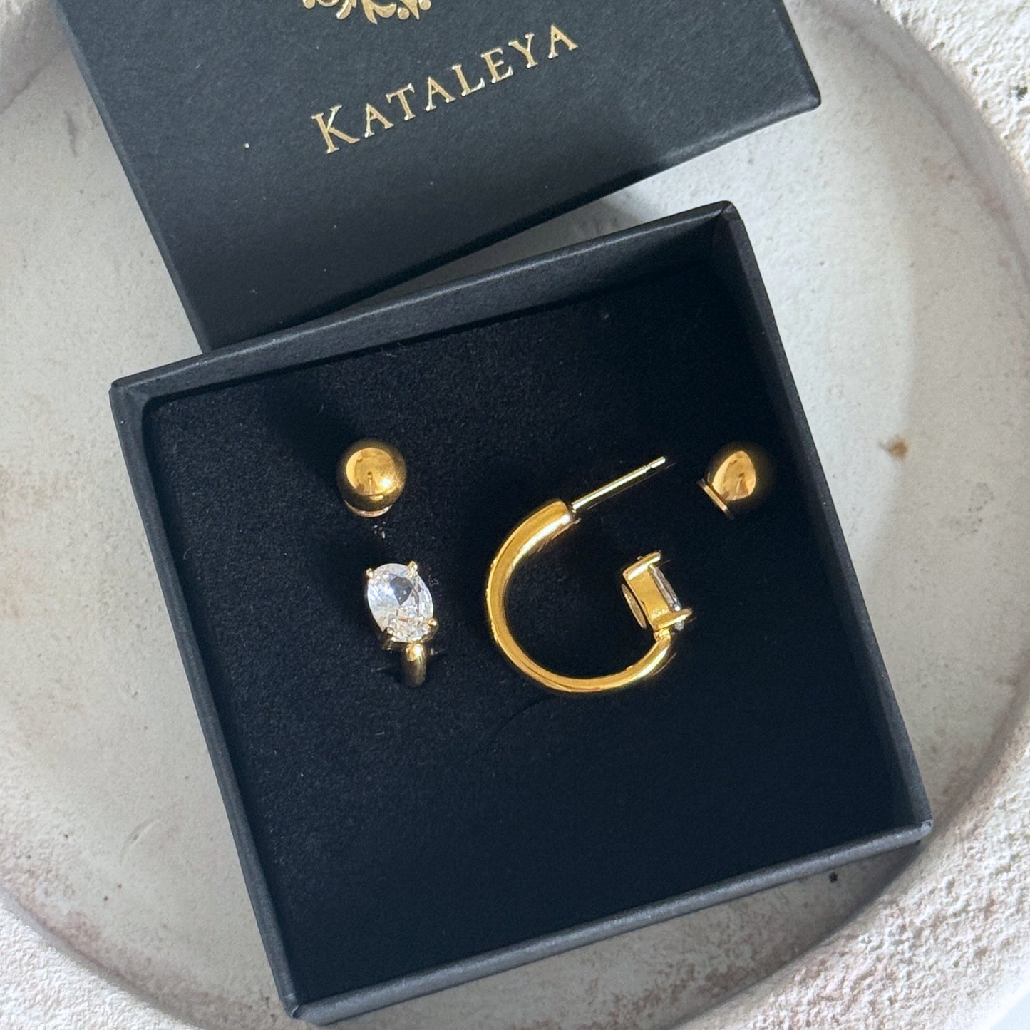 Gold Crystal Hoop Earrings in a black box, featuring cubic zirconia stones and waterproof design.