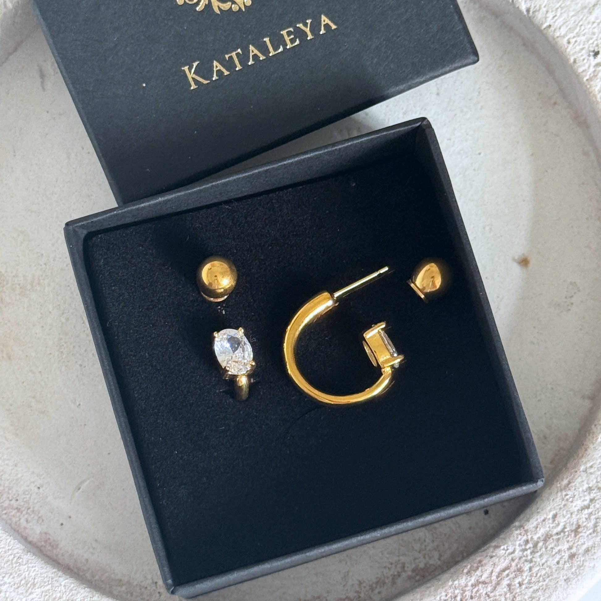 Gold Crystal Hoop Earrings in a black box, featuring cubic zirconia stones and waterproof design.