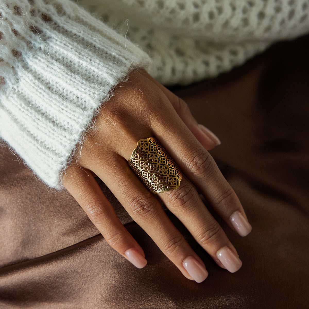 Statement Filigree Ring showcased on a hand with a cozy sweater, highlighting its intricate gold design.