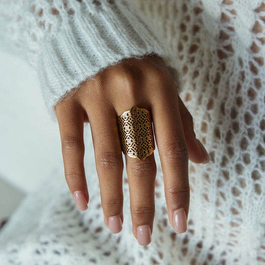 Statement Filigree Ring on a hand with delicate filigree design, showcasing waterproof and tarnish-free features.