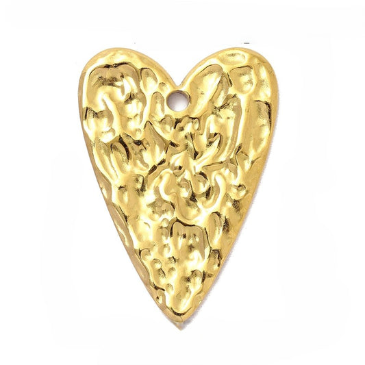 Gold heart-shaped charm with intricate design on a white background - Kataleya Jewellery