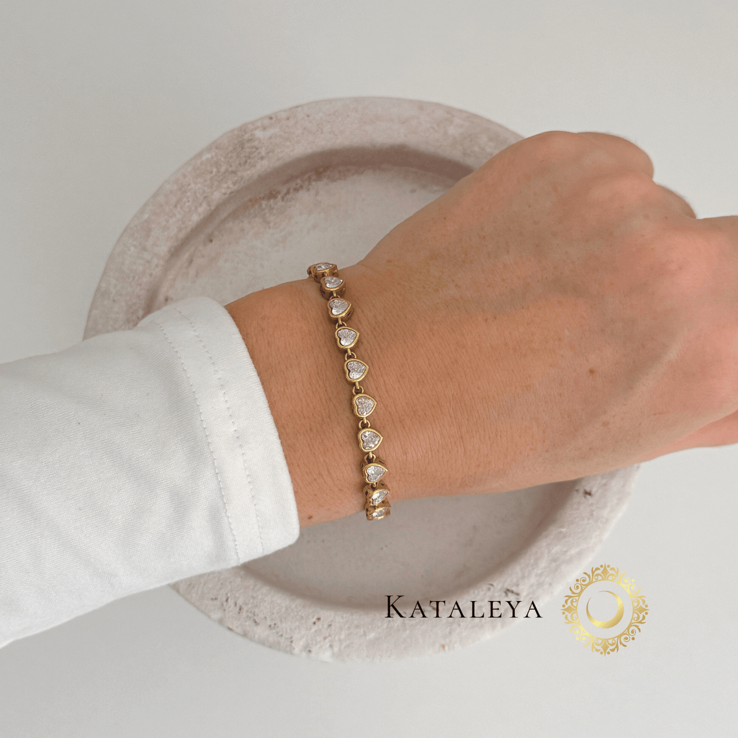 Heart Tennis Bracelet worn on hand, featuring heart-shaped cubic zirconia stones in a gold-plated design.