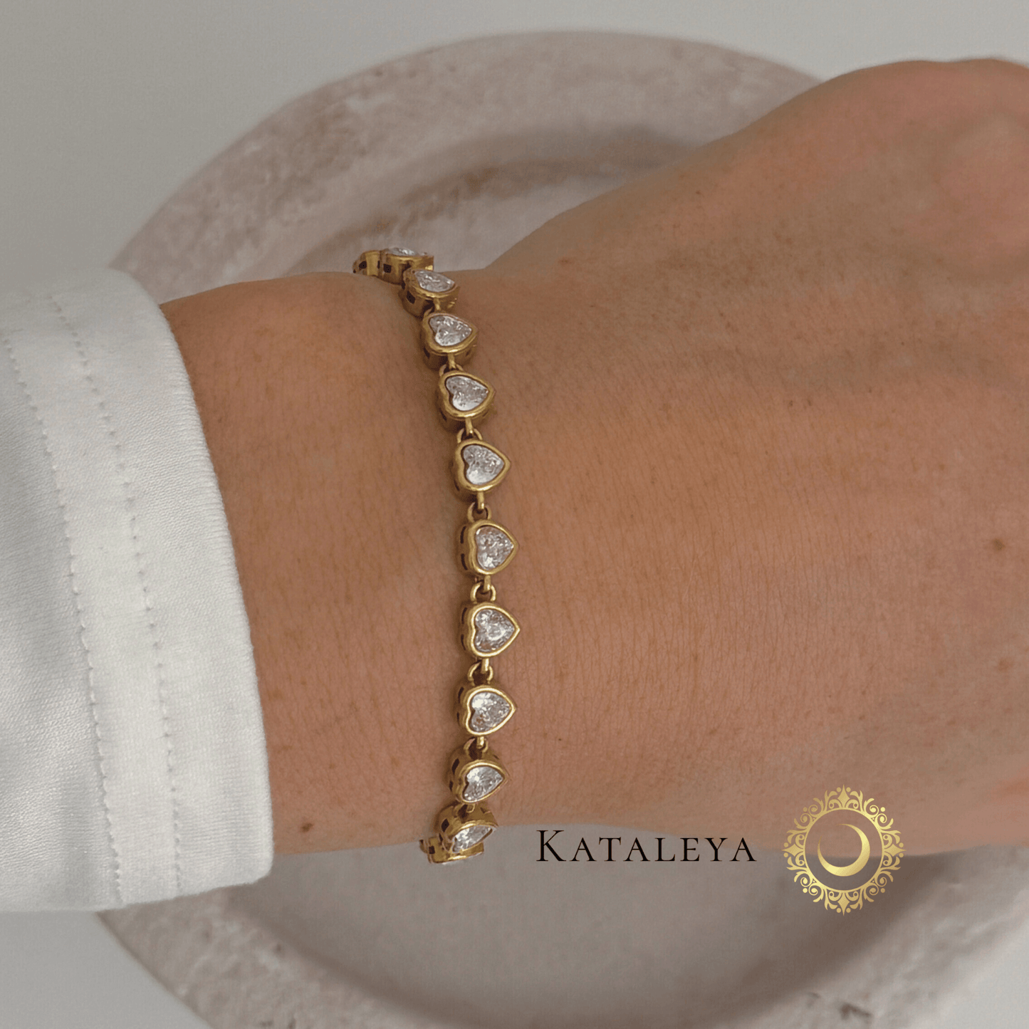 Heart Tennis Bracelet featuring heart-shaped cubic zirconia stones on a wrist, elegant gold-plated design.