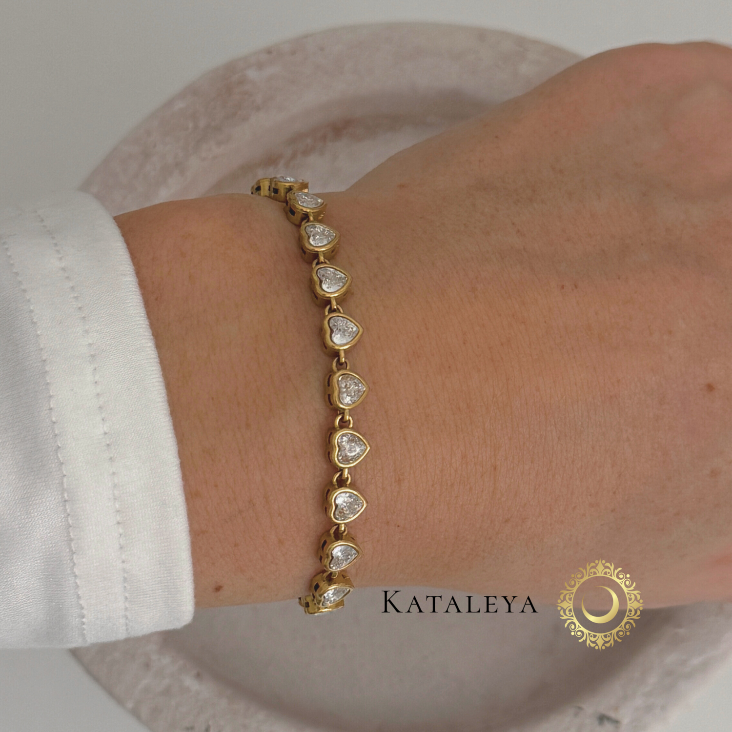 Heart Tennis Bracelet featuring heart-shaped cubic zirconia stones on a wrist, elegant gold-plated design.