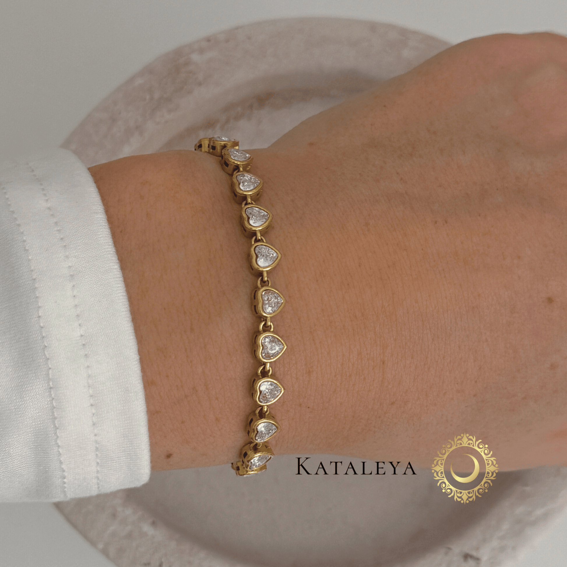 Heart Tennis Bracelet featuring heart-shaped cubic zirconia stones on a wrist, elegant gold-plated design.