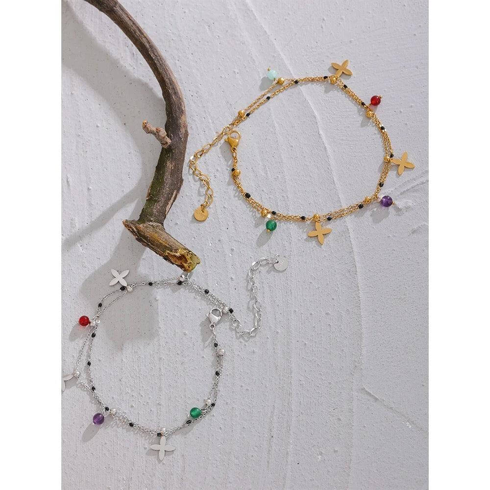 The Huacachina Anklet, embellished with colorful beads and golden flowers, is available in gold from Kataleya.