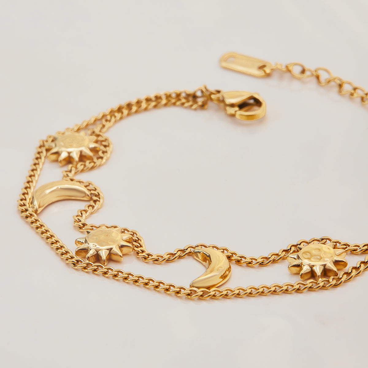 Celestial Harmony Bracelet featuring gold sun and moon charms with a delicate chain, waterproof and tarnish free.