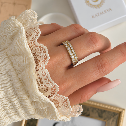 Scarlett Eternity Ring showcased on a hand, featuring round stones and a delicate lace sleeve.