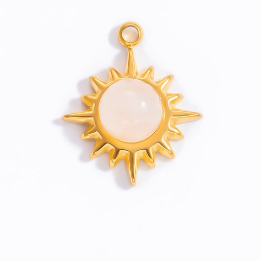Gold sun-shaped charm with a white center on a white background - Kataleya Jewellery